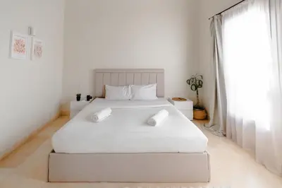 a white bedroom with a large white bed and a window at Modern Villa in El Gouna (Private Pool & Garden.) in Hurghada