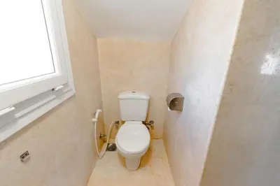 a bathroom with a toilet and a window at Modern Villa in El Gouna (Private Pool & Garden.) in Hurghada