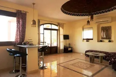 a living room with a bar and a couch at Nile Compound in Luxor