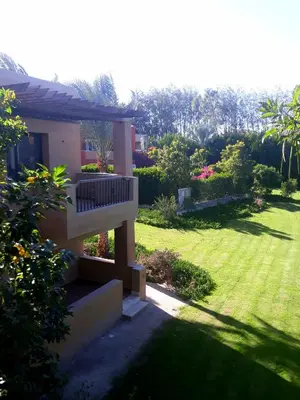 a house with a balcony and a yard at Апартаменты в Хургаде, Stella Makadi in Hurghada