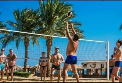 a group of men playing volleyball on a beach at Апартаменты в Хургаде, Stella Makadi in Hurghada