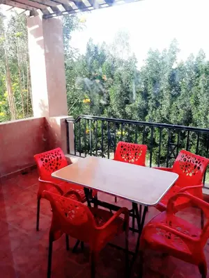 a white table and red chairs on a balcony at Апартаменты в Хургаде, Stella Makadi in Hurghada