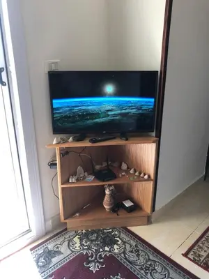 a flat screen tv sitting on a shelf in a room at Red Sea Tiba plaza Apartment in Hurghada