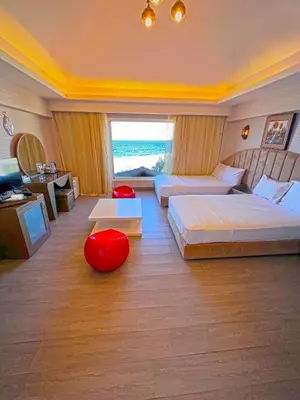 a hotel room with two beds and a large window at Luxury Seafront Pool Villa - 3 Stories & Roof floor - All Master Bedrooms in Hurghada