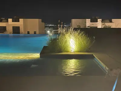 a swimming pool at night with some plants in it at Villa for you on your own in Makadi Heights, Hurghada, Read Sea, Egypt in Hurghada