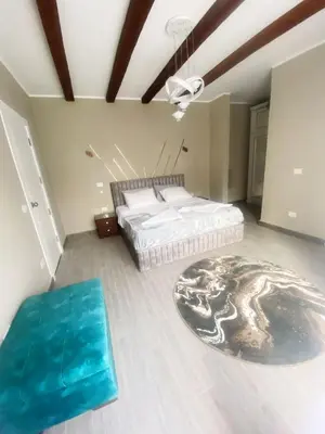 a bedroom with a large bed and a blue rug at LuxVilla 1 BHK W Private Heated Pool in Bali El Gouna in Hurghada