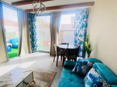 a living room with a blue couch and a table at LuxVilla 1 BHK W Private Heated Pool in Bali El Gouna in Hurghada