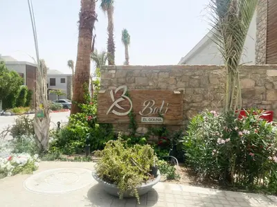 a sign for a but sign on a wall with plants at LuxVilla 1 BHK W Private Heated Pool in Bali El Gouna in Hurghada