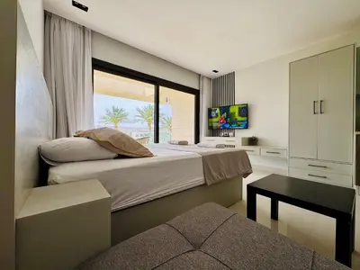 a bedroom with a large bed with a window at Cozy Studio Apt @ G-cribs El Gouna with a View. in Hurghada