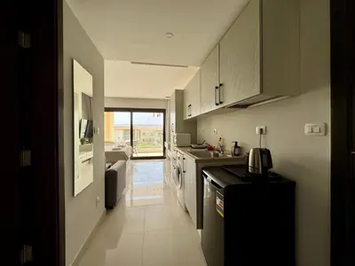 a kitchen with a sink and a counter at Cozy Studio Apt @ G-cribs El Gouna with a View. in Hurghada