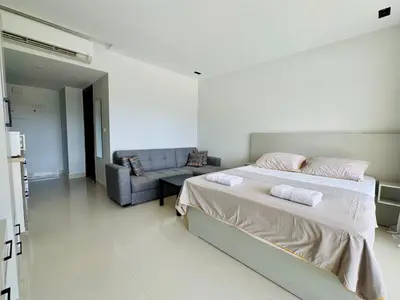a bedroom with a bed and a couch at Cozy Studio Apt @ G-cribs El Gouna with a View. in Hurghada