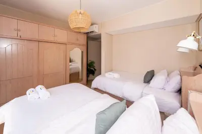 two beds in a room with white sheets at Dashing 2 BDR Mangroovy Free Pool & Beach Access in Hurghada