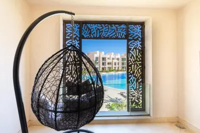 a hanging basket in front of a window at Dashing 2 BDR Mangroovy Free Pool & Beach Access in Hurghada