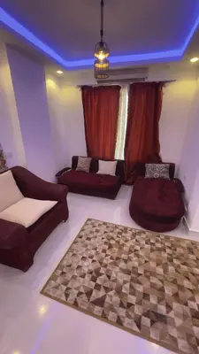 a living room with two beds and a couch at Palma house apartments A8 in Hurghada