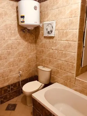 a bathroom with a toilet and a bath tub at Palma house apartments A8 in Hurghada
