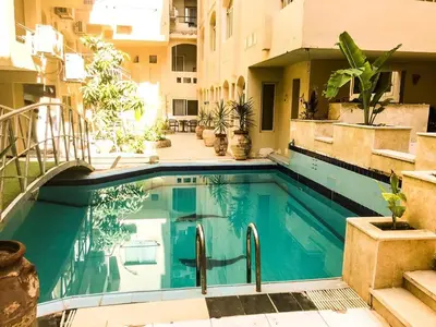 a swimming pool in the middle of a building at Palma house apartments A8 in Hurghada