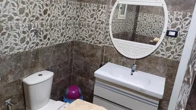 a bathroom with a toilet and a sink and a mirror at Sun & Fun in Quseir