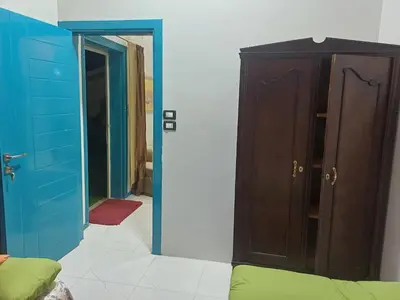 a room with a closet and a cabinet and a door at Sun & Fun in Quseir