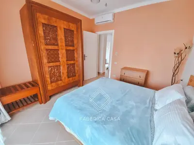 a bedroom with a bed and a wooden door at Beautiful 1 bedroom apartment in Quseir