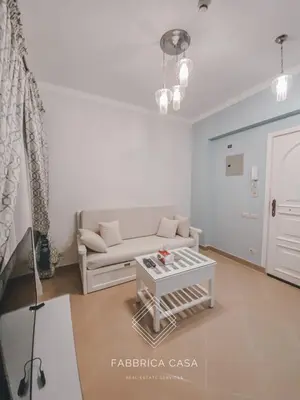 a living room with a couch and a table at Beautiful 1 bedroom apartment in Quseir