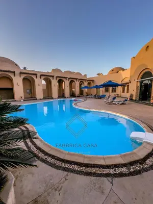 a swimming pool in the courtyard of a building at Beautiful 1 bedroom apartment in Quseir