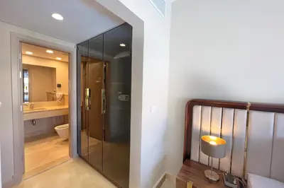 a bathroom with a glass shower and a toilet at Homestyle 3BR Penthouse Pool & Beach View in Hurghada