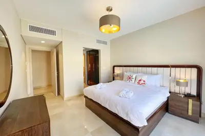 a bedroom with a large bed with towels on it at Homestyle 3BR Penthouse Pool & Beach View in Hurghada