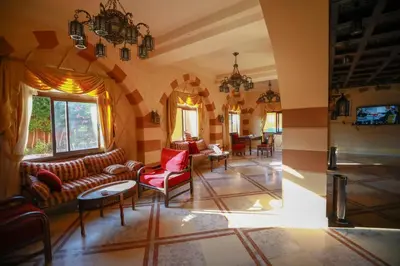 a living room with couches and chairs and a tv at Marina view port ghalib in Port Ghalib