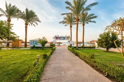 a path through a park with palm trees at Sentido Caribbean World Soma Bay in Hurghada