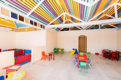 a room with brightly colored tables and chairs at Sentido Caribbean World Soma Bay in Hurghada
