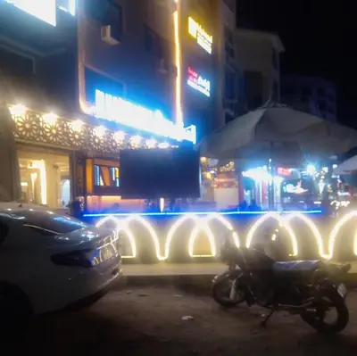 a motorcycle parked in front of a building at night at Yasin - Enjoy the privacy of staying in a quiet apartment with free Wi-Fi as your complete second home in the heart of Hurghada in Hurghada