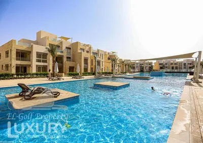 a pool at a resort with people swimming in it at Mangarov-2BR. M1-6b-12 in Hurghada