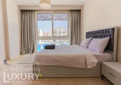a bedroom with a large bed and a large window at Mangarov-2BR. M1-6b-12 in Hurghada