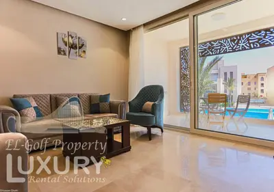 a living room with a couch and chairs and a patio at Mangarov-2BR. M1-6b-12 in Hurghada