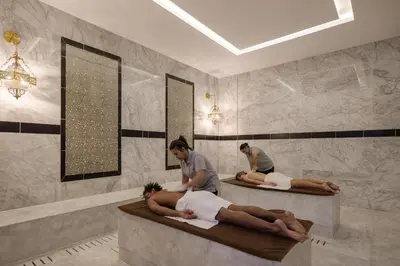 a couple of people laying in beds in a bathroom at Xanadu Makadi Bay - High Class All Inclusive in Hurghada