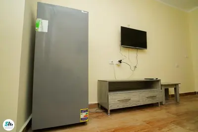 a room with a sliding door with a tv and a table at Florenza khamsin home Hurghada in Hurghada