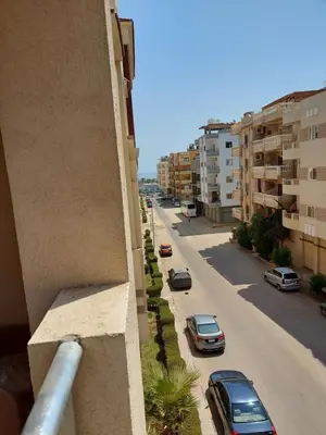 a street with cars parked on the side of a building at Florenza khamsin home Hurghada in Hurghada