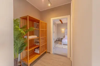 a room with a book shelf with a plant in it at Modern 1 Bedroom Apartment Bali El Gouna Private Patio & Heated Pool in Hurghada