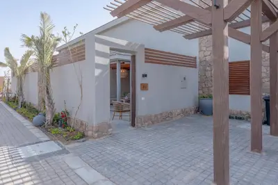 a white house with a porch and a patio at Modern 1 Bedroom Apartment Bali El Gouna Private Patio & Heated Pool in Hurghada