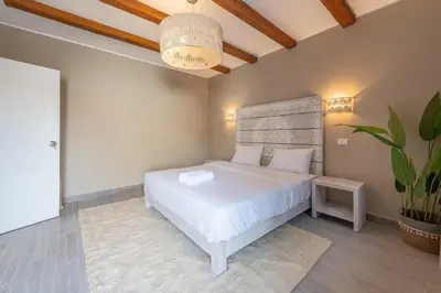 a bedroom with a white bed and a potted plant at Modern 1 Bedroom Apartment Bali El Gouna Private Patio & Heated Pool in Hurghada