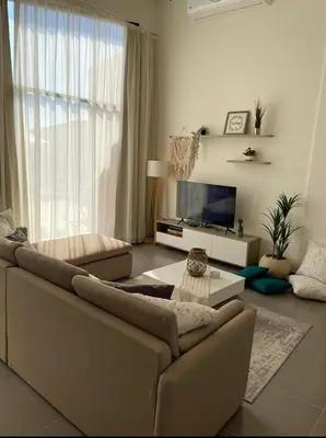 a living room with a couch and a tv at Somabay BW Villa - families only in Hurghada