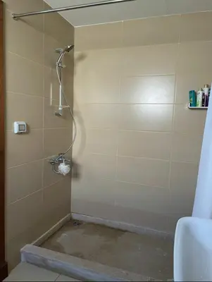 a shower in a bathroom with a tile wall at Somabay BW Villa - families only in Hurghada