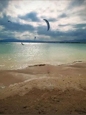 a person is flying a kite on the beach at Somabay BW Villa - families only in Hurghada