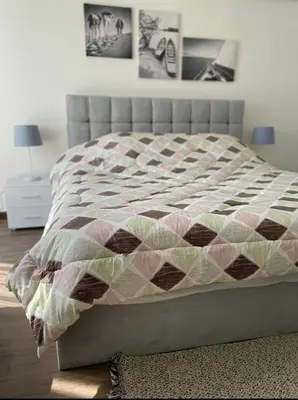 a bed with a quilt on it in a bedroom at Somabay BW Villa - families only in Hurghada