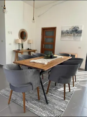 a dining room with a wooden table and chairs at Somabay BW Villa - families only in Hurghada