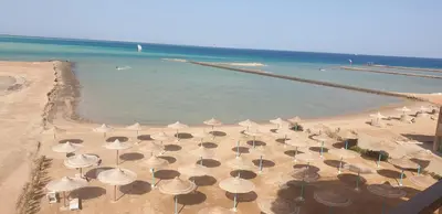 an overhead view of a beach with umbrellas and the ocean at Casablanca resort in Hurghada