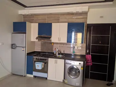a kitchen with a refrigerator and a washing machine at Casablanca resort in Hurghada