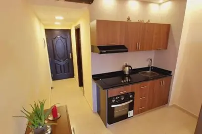 a small kitchen with a sink and a stove at Florenza Khamsin - sea view / free Wi-Fi in Hurghada