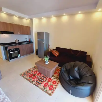 a living room with a leather couch and a coffee table at Florenza Khamsin - sea view / free Wi-Fi in Hurghada