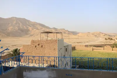 a brick building in the middle of the desert at Ahmed Mulatam House in Luxor